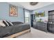 Well-lit bedroom with blue walls, black furniture, and a flatscreen TV on the wall at 17316 Cruiser Bnd, Land O Lakes, FL 34638