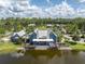 Beautiful clubhouse overlooking a scenic pond with a lush green lawn and mature trees at 17316 Cruiser Bnd, Land O Lakes, FL 34638