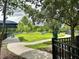 Fenced dog park featuring green space, shade trees, a walking path, and playground equipment at 17316 Cruiser Bnd, Land O Lakes, FL 34638
