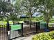 Fenced dog park featuring green space, shade trees, and playground equipment for large dogs at 17316 Cruiser Bnd, Land O Lakes, FL 34638