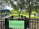 Fenced small dog park featuring green space, shade trees, and playground equipment for small dogs at 17316 Cruiser Bnd, Land O Lakes, FL 34638