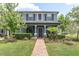 Inviting two-story home featuring a lush landscaped front yard and covered entryway at 17316 Cruiser Bnd, Land O Lakes, FL 34638
