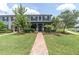 Charming blue townhome with black shutters, landscaped yard, and brick walkway at 17316 Cruiser Bnd, Land O Lakes, FL 34638