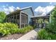 The game room features a screened-in porch and inviting entrance, surrounded by lush landscaping at 17316 Cruiser Bnd, Land O Lakes, FL 34638