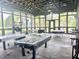 Spacious game room with ample natural light, ping pong tables, and other game equipment at 17316 Cruiser Bnd, Land O Lakes, FL 34638