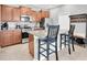 Modern kitchen featuring stainless steel appliances, granite countertops, and a convenient island with seating at 17316 Cruiser Bnd, Land O Lakes, FL 34638