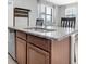 View of kitchen island with granite countertop, stainless steel dishwasher and sink at 17316 Cruiser Bnd, Land O Lakes, FL 34638