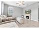 Living room with tile floors, a comfortable sectional sofa, decorative fireplace, and lots of natural light at 17316 Cruiser Bnd, Land O Lakes, FL 34638