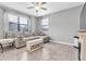 Neutral living room with tile floors, large sectional couch, and decorative pieces at 17316 Cruiser Bnd, Land O Lakes, FL 34638