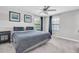 Bedroom with a ceiling fan, two windows, and tastefully decorated walls at 17316 Cruiser Bnd, Land O Lakes, FL 34638