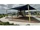 Playground with shade structure in the Bexley community at 17316 Cruiser Bnd, Land O Lakes, FL 34638