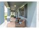Cozy front porch with wicker furniture; a relaxing outdoor space at 17316 Cruiser Bnd, Land O Lakes, FL 34638