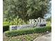 Community sign with 'BEXLEY CLUB' surrounded by manicured hedges and colorful flowers at 17316 Cruiser Bnd, Land O Lakes, FL 34638