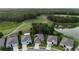 Beautiful aerial view of home with golf course, pond, and mature trees in the background at 17679 Garsalaso Cir, Brooksville, FL 34604