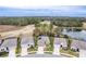 Wide aerial perspective featuring homes with lush greenery, golf course, and pond at 17679 Garsalaso Cir, Brooksville, FL 34604