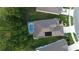 Aerial view shows a screened in swimming pool and solar panels on roof at 17679 Garsalaso Cir, Brooksville, FL 34604