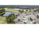 Elevated image of residences and recreational amenities like a pool, lake, and golf course at 17679 Garsalaso Cir, Brooksville, FL 34604
