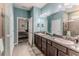 Bathroom featuring dual sinks, granite counters, and access to the Primary bedroom at 17679 Garsalaso Cir, Brooksville, FL 34604