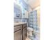 Cozy bathroom featuring a shower-tub combo, dark vanity, and modern fixtures at 17679 Garsalaso Cir, Brooksville, FL 34604