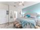 Bright bedroom with a large bed, soft carpet, and a view to an ensuite bathroom at 17679 Garsalaso Cir, Brooksville, FL 34604
