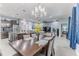 Elegant dining area with stylish chandelier, open layout to living room and modern kitchen at 17679 Garsalaso Cir, Brooksville, FL 34604