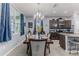 Dining room features an elegant chandelier, wooden table, and chairs with dark wood cabinets at 17679 Garsalaso Cir, Brooksville, FL 34604