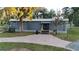 Exterior view of recreation center building, featuring covered entrance, paved walkway, and ample parking space at 17679 Garsalaso Cir, Brooksville, FL 34604