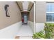 Inviting front entrance featuring a decorative door, sconces, and a well-maintained walkway at 17679 Garsalaso Cir, Brooksville, FL 34604