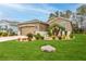 Charming home with lush landscaping, green grass, and beautiful exterior at 17679 Garsalaso Cir, Brooksville, FL 34604