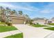 Beautifully landscaped house with a two-car garage and inviting curb appeal at 17679 Garsalaso Cir, Brooksville, FL 34604