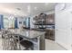 Modern kitchen features stainless steel appliances, granite countertops, and a stylish breakfast bar with seating at 17679 Garsalaso Cir, Brooksville, FL 34604