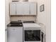 Functional laundry room with modern appliances and overhead cabinets for storage at 17679 Garsalaso Cir, Brooksville, FL 34604