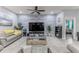 Modern living room with stylish decor, a gray accent wall, and comfortable seating at 17679 Garsalaso Cir, Brooksville, FL 34604
