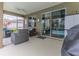 Relaxing screened-in patio area with wicker furniture and a view of the pool and landscaped backyard at 17679 Garsalaso Cir, Brooksville, FL 34604