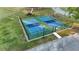 Overhead view of outdoor pickleball courts surrounded by fencing and landscaping at 17679 Garsalaso Cir, Brooksville, FL 34604