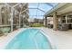 Beautiful backyard featuring a screened pool, patio area, and landscaped green space, perfect for outdoor enjoyment at 17679 Garsalaso Cir, Brooksville, FL 34604