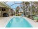 Backyard pool area with a screened-in pool and view of the yard and screened-in patio at 17679 Garsalaso Cir, Brooksville, FL 34604