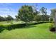 Beautiful backyard view overlooking the golf course and lush greenery, creating a serene outdoor space at 17727 Garsalaso Cir, Brooksville, FL 34604