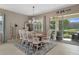 Elegant dining room with chandelier lighting, views of the backyard, and comfortable seating for Gathering gatherings at 17727 Garsalaso Cir, Brooksville, FL 34604