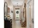 Welcoming entryway featuring a decorative mirror and storage bench, leading to a glass-paneled front door at 17727 Garsalaso Cir, Brooksville, FL 34604