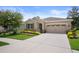 Well maintained home with a manicured lawn, colorful flowerbeds, and a spacious two-car garage at 17727 Garsalaso Cir, Brooksville, FL 34604