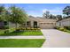 Well maintained home with a lush green lawn, beautiful flowerbeds, and a two-car garage at 17727 Garsalaso Cir, Brooksville, FL 34604