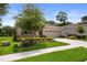 Charming home with a well-manicured lawn, colorful landscaping, and a spacious two-car garage at 17727 Garsalaso Cir, Brooksville, FL 34604
