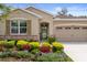 Close-up shot of front of house with colorful flowerbeds, stone accents and a well manicured front yard at 17727 Garsalaso Cir, Brooksville, FL 34604