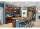 Modern kitchen features granite countertops, stainless steel appliances, and a breakfast bar with seating for three at 17727 Garsalaso Cir, Brooksville, FL 34604