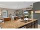 A spacious kitchen island overlooks a well lit dining and living room area at 17727 Garsalaso Cir, Brooksville, FL 34604