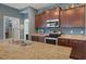 Kitchen showcasing granite countertops, stainless steel appliances, and a center island with a sink at 17727 Garsalaso Cir, Brooksville, FL 34604