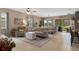 Bright and airy living room boasts neutral decor, plush seating, and a sliding glass door with backyard views at 17727 Garsalaso Cir, Brooksville, FL 34604