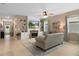 Open-concept living room with fireplace, built-ins, and view to the front door. Neutral walls and tile flooring throughout at 17727 Garsalaso Cir, Brooksville, FL 34604