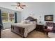 Comfortable main bedroom featuring natural light, a ceiling fan, and decor at 17727 Garsalaso Cir, Brooksville, FL 34604